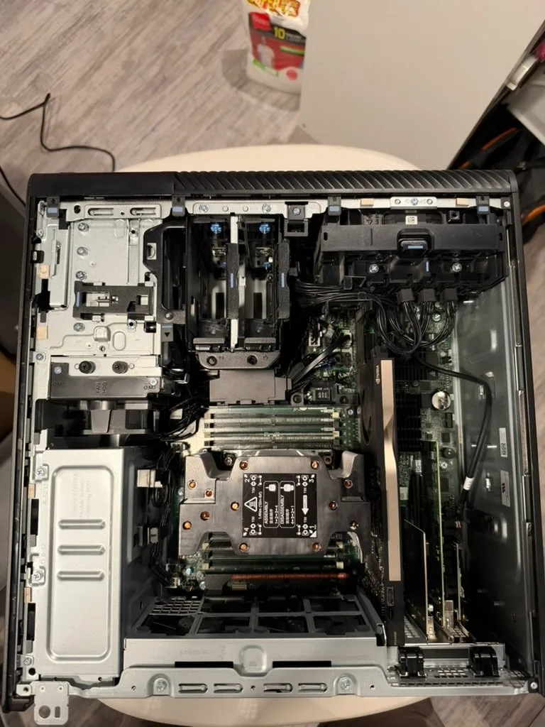 Air shroud removed: CPU heatsink between the DIMM slots, with a workstation GPU and add-in cards in the PCIe slots.