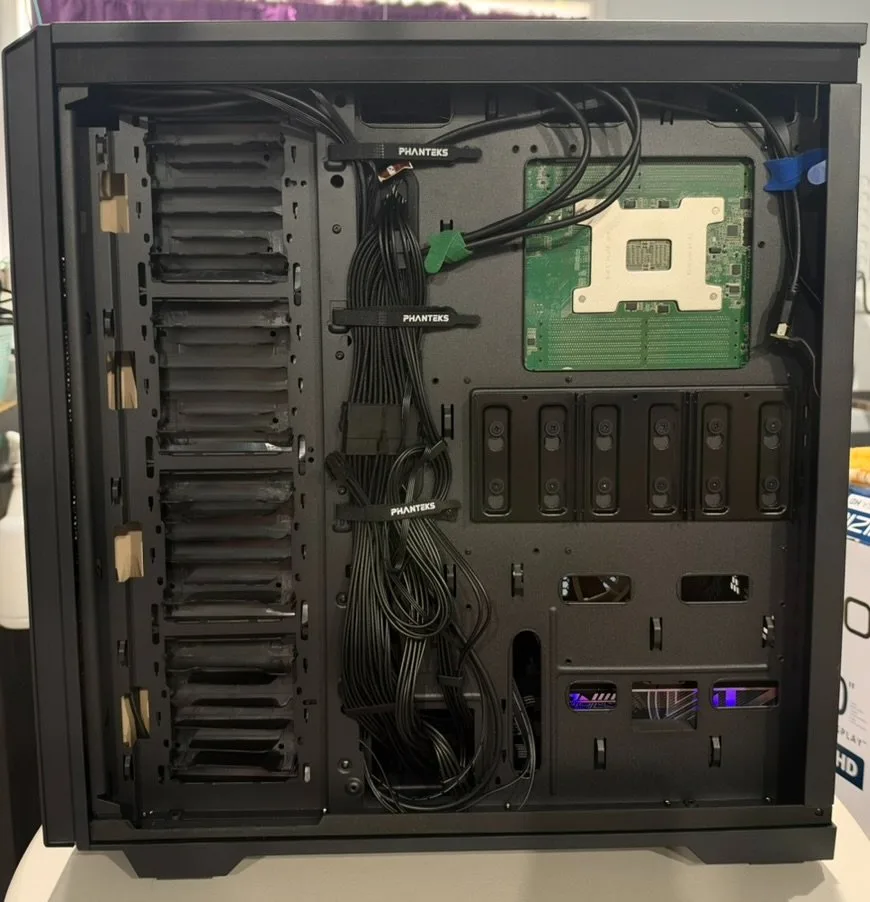 Behind the motherboard tray: the Phanteks case with the power cables strapped down.