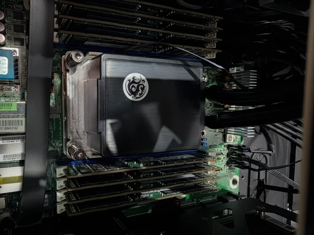 EPYC 7402P under its cooler, with eight DDR4 ECC RDIMMs on either side of the socket.