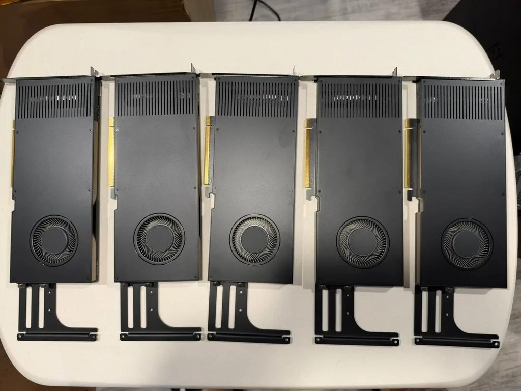 Five cards, shroud side up, with support arms attached.