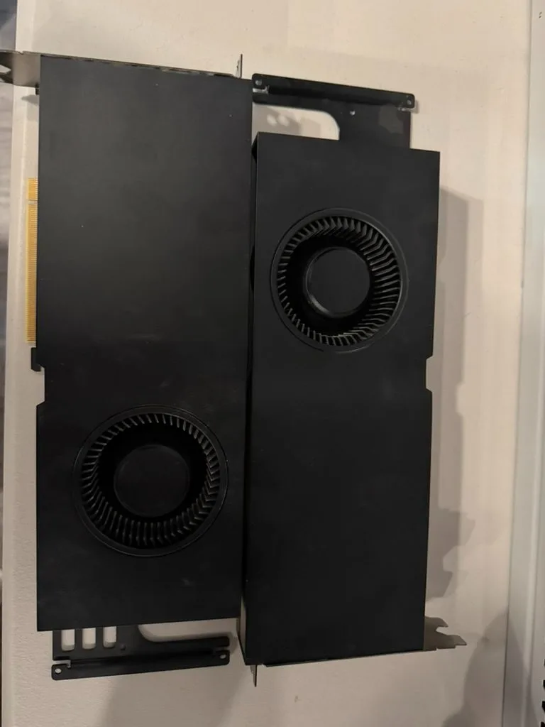 Two RTX A5000 cards, blower side up, one with its rear support bracket.