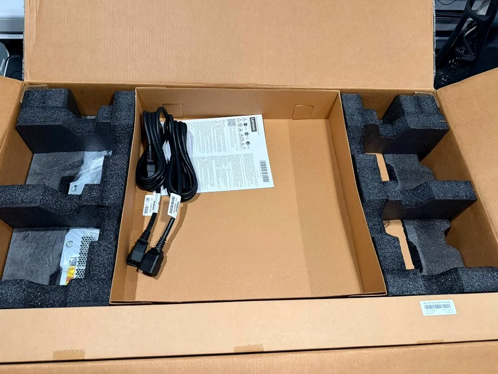 Accessory tray as packed: power cords, documentation, and foam-seated components.